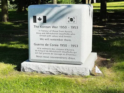 Memorial stone sitting on a green lawn