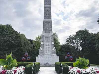 1)	Aurora-Whitchurch-King War Memorial statue surrounded by greenery and trees